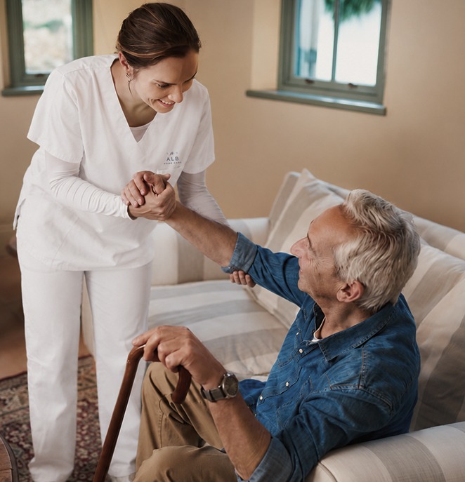 Caretaker helping person stand up
