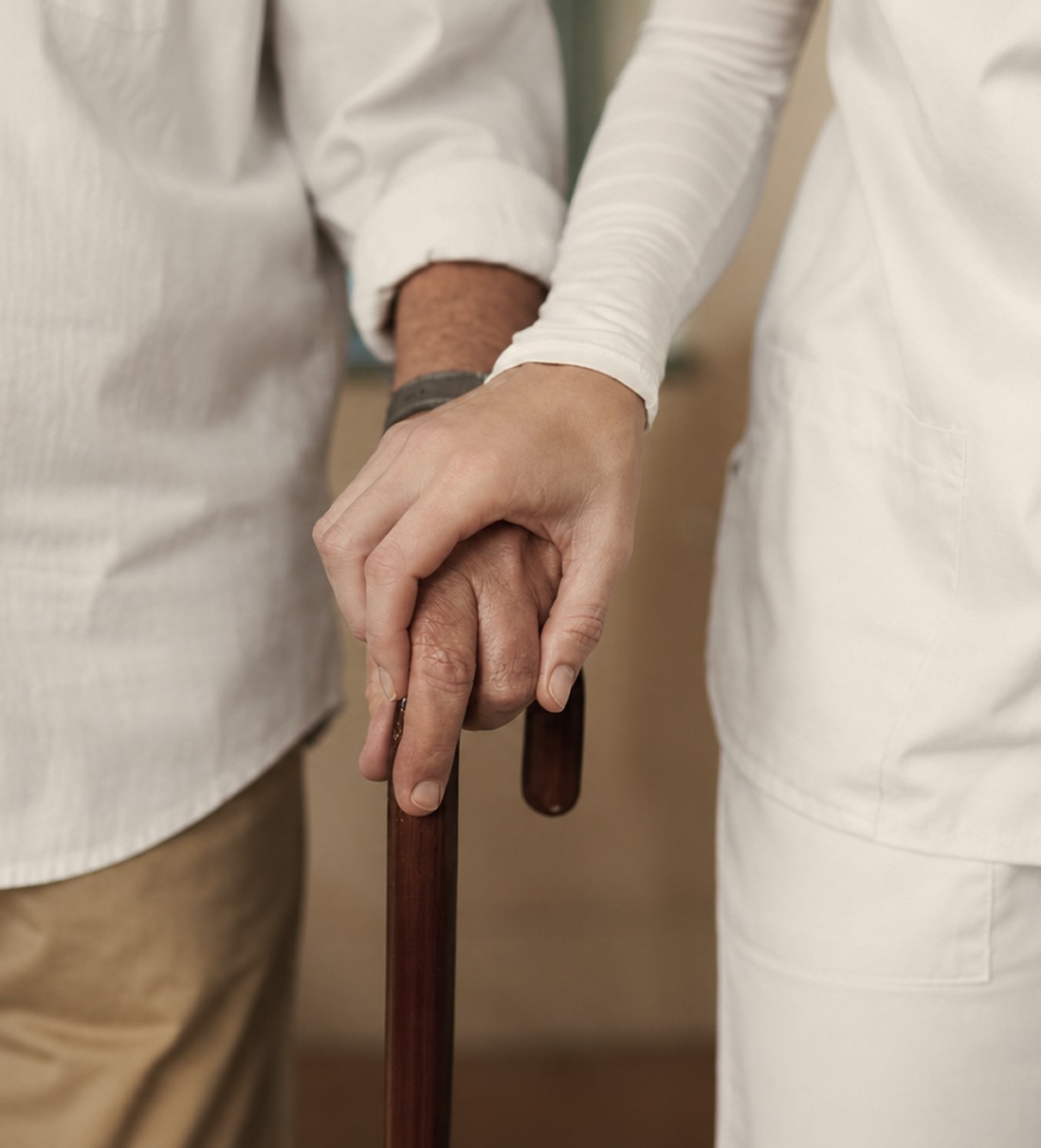 Caretaker holding person's hand