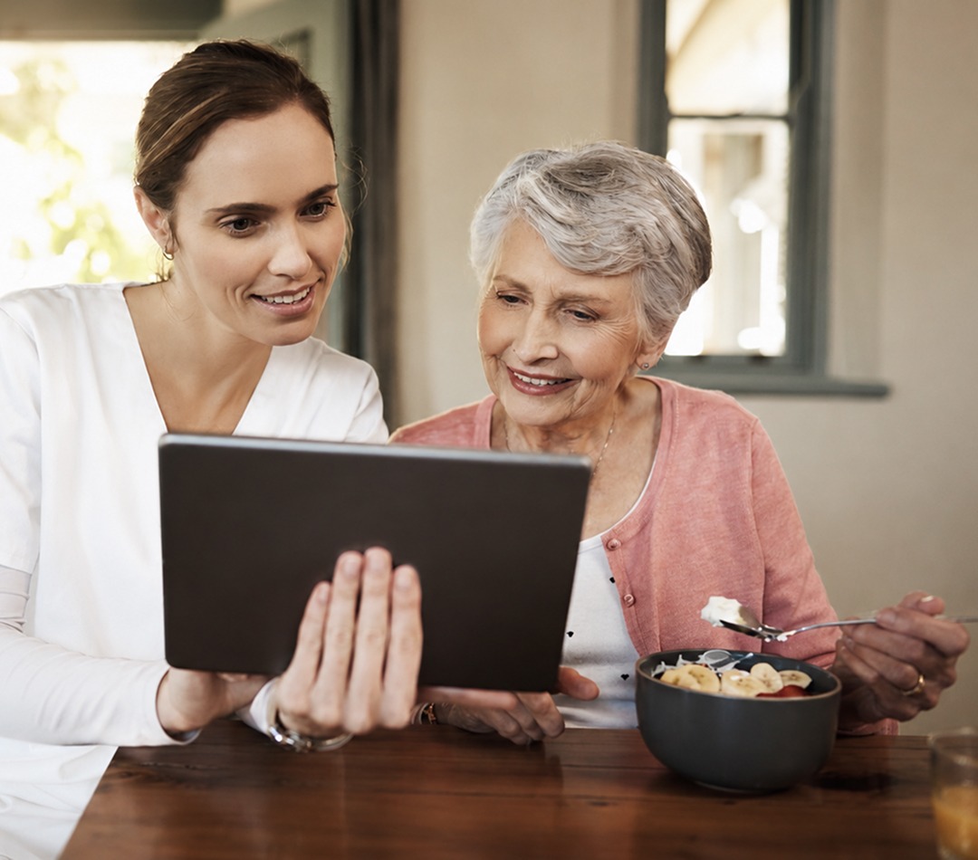Caretaker helping person with tablet device