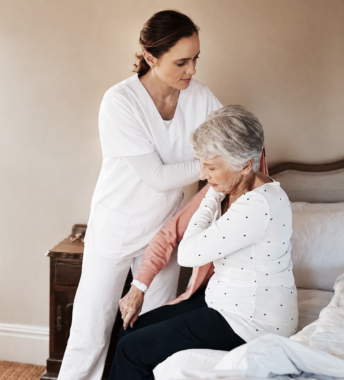 Caretaker helping person with getting dressed