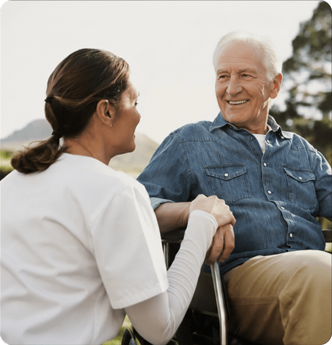 Caretaker comforting person in wheelchair